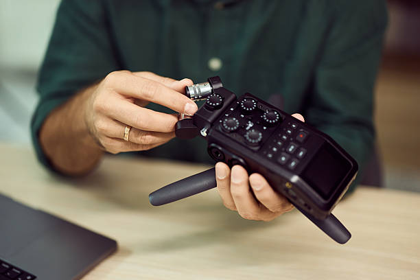 istock Person Operating a Professional Audio Recorder in a Studio Environment 2204319692