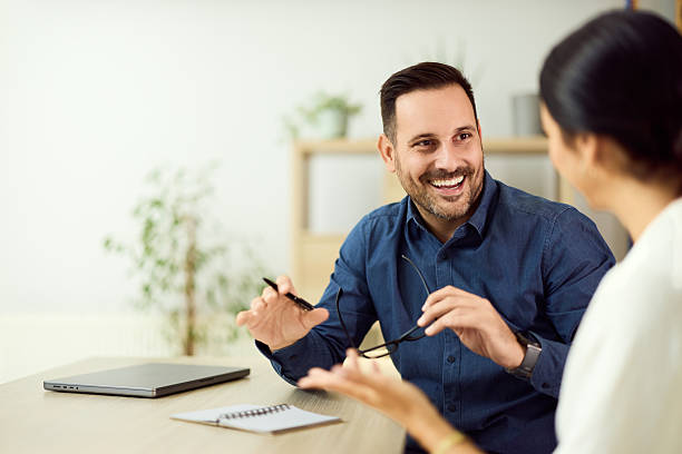 Two Colleagues Engaging in Positive Discussion at a Professional Workspace stock photo
