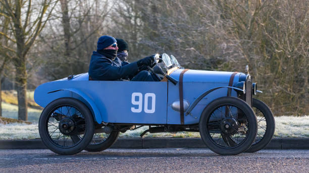 1924 ,blue, Austin 7 ,sports ,vintage car,Stony Stratford,UK - Mar. 2nd 2025: 1924 blue Austin 7 sports vintage car  driving on a British road.