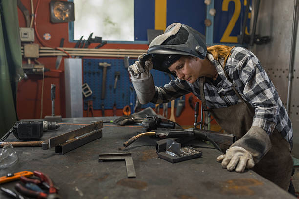 istock Woman welder in protective gear 2204325851