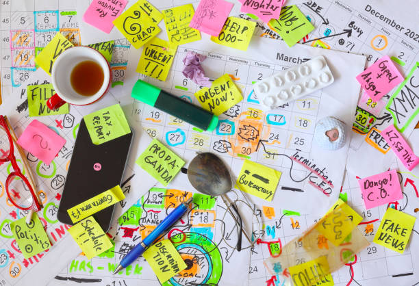istock Calendars with business appointments,termination notice and adhesive notes on cluttered desk. Business concept,beat the clock,overwoked,bureaucracy 2204326744