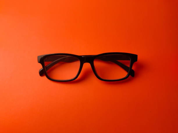 istock Top view black glasses on a orange background 2204327359