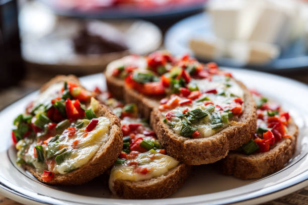 A Fried Bread Like Small Pizza with Pepper Tomato and Melted Cheese On