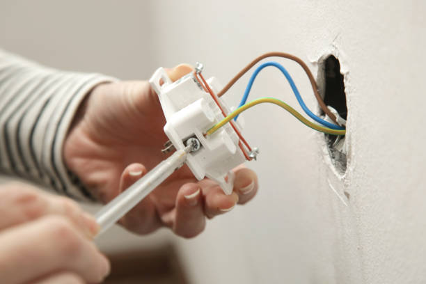 istock Electrical Outlet Repairing and Assembling - home improvement concepts. Master electrician installs a socket in the house. DIY home project. 2204327810