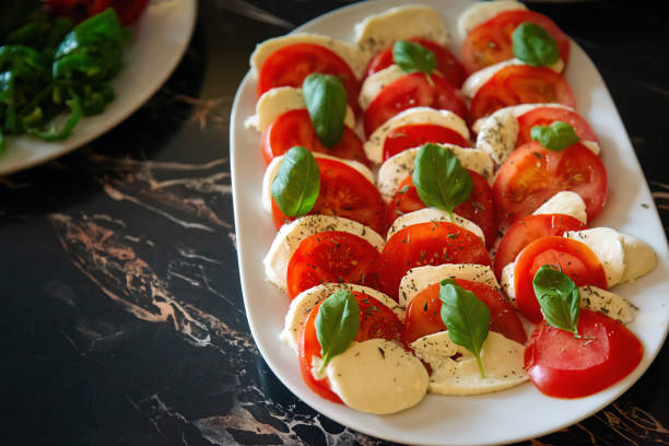 istock Sliced Tomato and Cheese on a Plate 2204327942