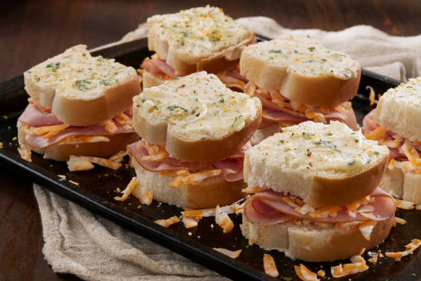 istock Preparing The Trendy Mini Baked Grilled Cheese and Ham Sandwiches 2204328539