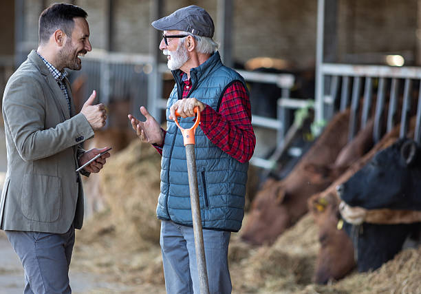 istock Businessman and farmer talking on ranch 2204329518