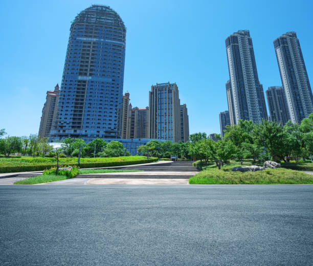 istock Empty asphalt road with modern cityscape and sunny blue sky background 2204330057