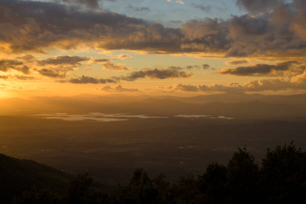 istock Autumn sunset light with clouds in blue sky with mountain landscape between the trees in horizontal HDR 2204330500