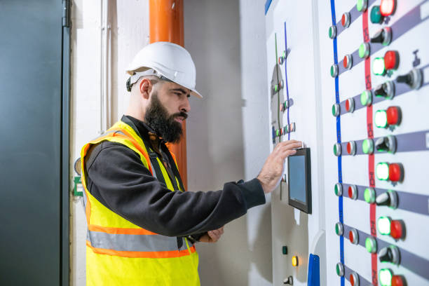 istock An electrical engineer is in front of an electrical panel controlling the power of a power management building. 2204332587