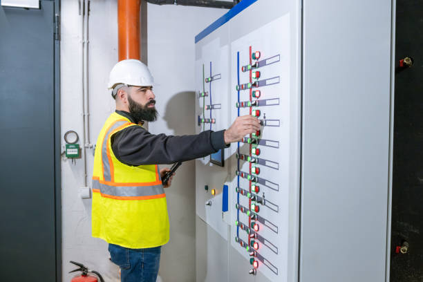 istock An electrical engineer is in front of an electrical panel controlling the power of a power management building. 2204332615