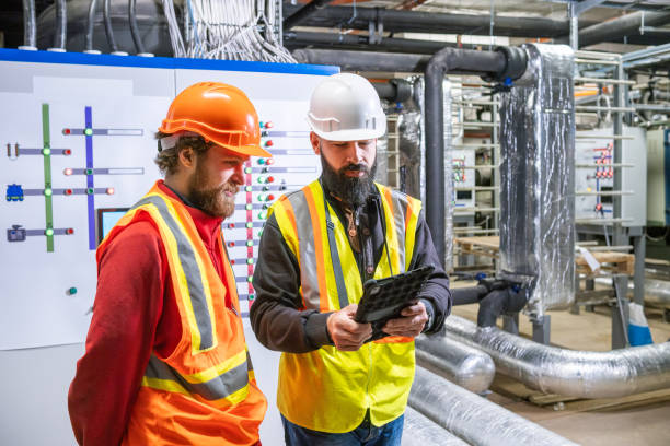 istock Engineer and technician in the control room for power control of a large building. 2204332645