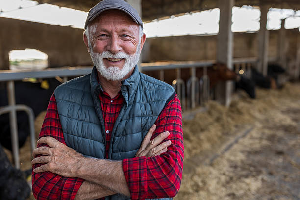 istock Farmer standing in front of cattle ranch 2204332679