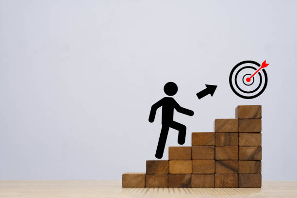 istock A conceptual image depicting a figure climbing stairs towards a target, symbolizing ambition, goal achievement, and motivation in the business world. 2204333974