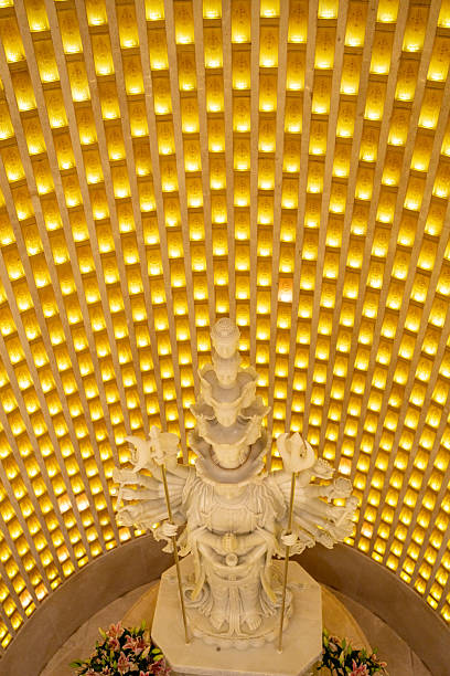 A stunning statue is beautifully illuminated beneath a golden glow, creating an enchanting ambiance