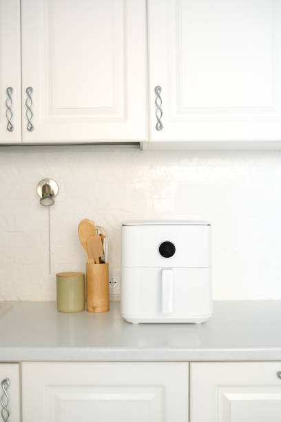 istock An elegant kitchen space featuring a stylish white air fryer, with clean lines and a beautifully minimalist decor. 2204337883