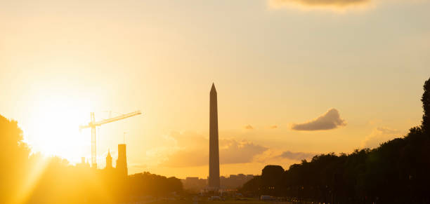 Sun shining over Washington Monument at sunset