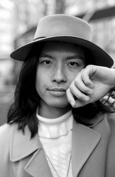 Young and stylish model posing with hand on chin in monochrome