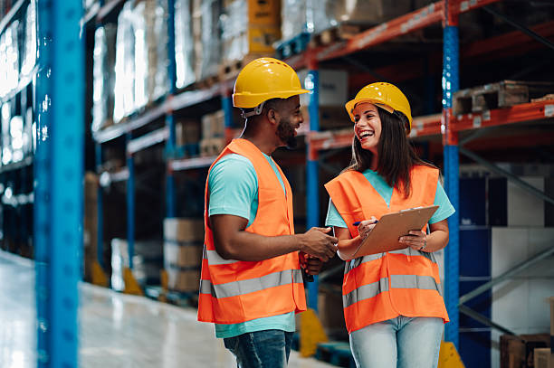 istock Warehouse workers discussing logistics and inventory management with clipboards 2204342132