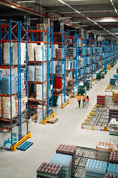 istock Warehouse workers walking and controlling goods and products on shelves 2204342209