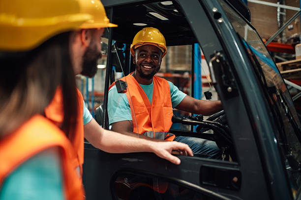 istock Warehouse workers talking near forklift in logistics center 2204342374