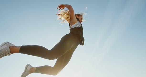 istock Dynamic and Energetic Jump Against a Bright and Beautiful Sky During Summer Days 2204343211