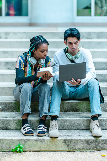 istock College Students Discussing a Project Outdoors 2204343413
