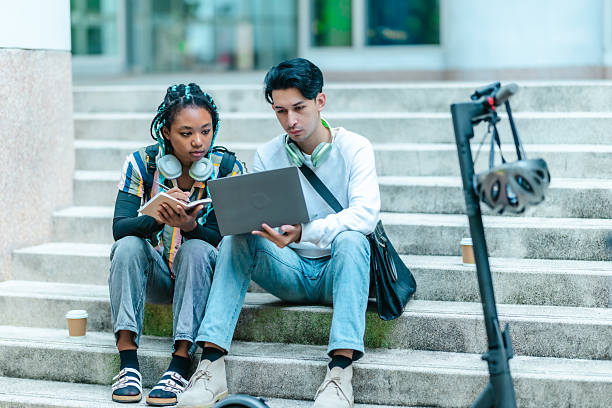 istock College Students Discussing a Project Outdoors 2204344777