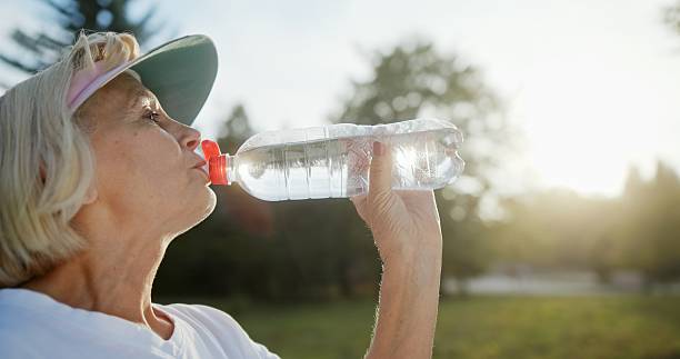 istock A Senior Lady Relishes a Refreshing Drink While Enjoying the Outdoors in Natures Embrace 2204345261