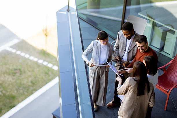 istock Team collaboration in a modern office space during a sunny afternoon meeting outside 2204345640