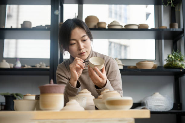 istock asian woman making ceramic pots in the ceramic workshop 2204348735