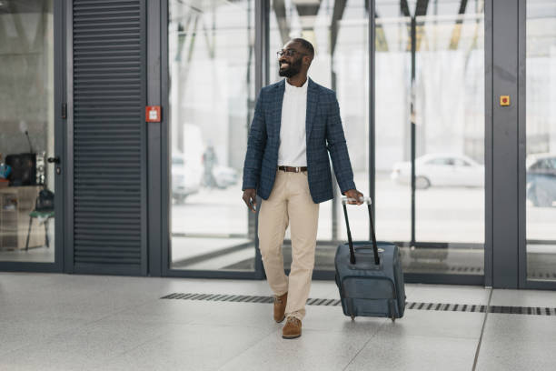 istock Professional man walking with suitcase at airport 2204349824