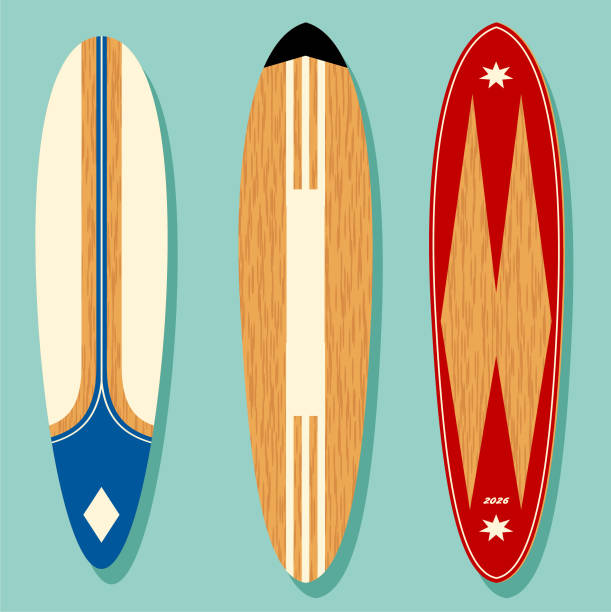 3  vintage shaped wooden surfboards with retro graphics standing upright in a group. Free floating on a turquoise background