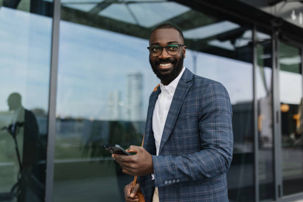 istock Smartly dressed man smiling at camera outdoors 2204350968