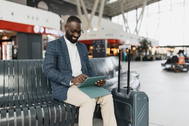 istock Businessman Enjoying Tablet While Relaxing at Terminal 2204351491