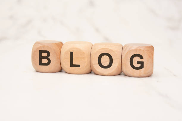 wooden blocks spelling the word BLOG on a marble surface, symbolizing online content creation