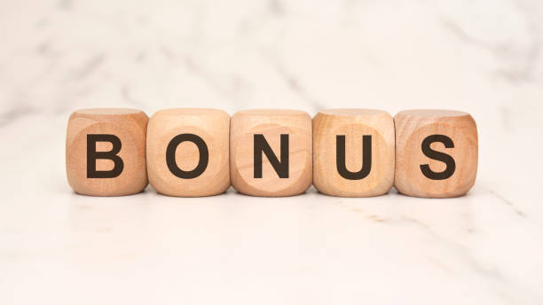 istock wooden blocks spelling BONUS on a marble surface, symbolizing rewards and extra benefits 2204353179