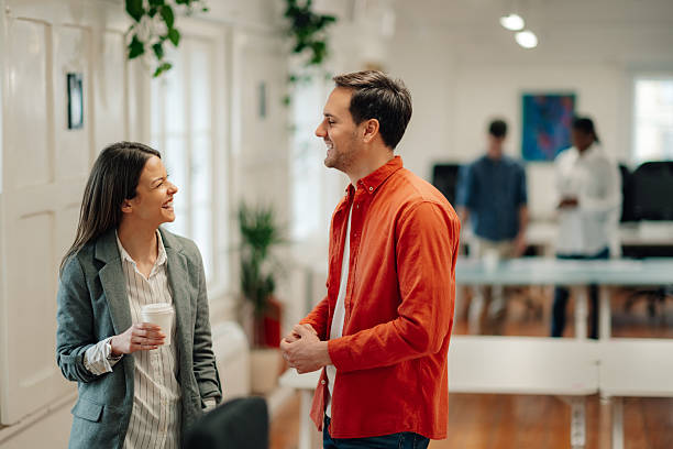 Business colleagues engaging in friendly conversation during office break