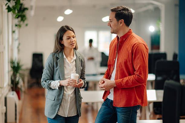 istock Businesspeople chatting during coffee break in modern office 2204354160