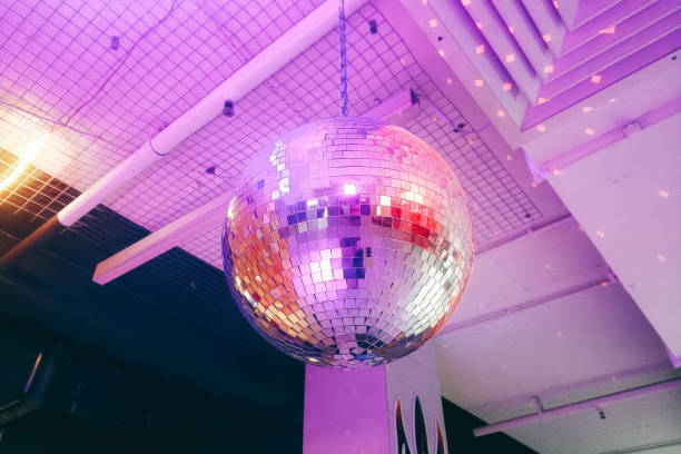 istock A large disco ball hangs from the ceiling, illuminating the space 2204354609