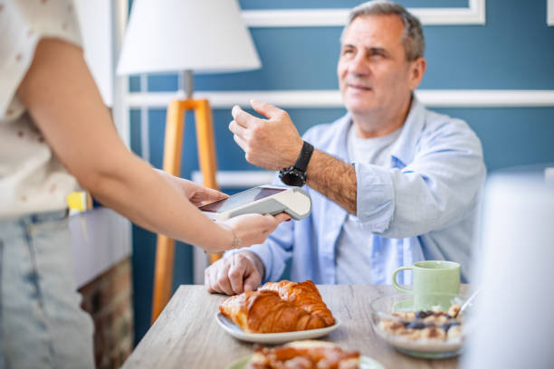 istock Paying for brunch at a restaurant using contactless technology and mobile devices in a modern setting 2204355301