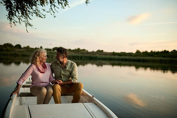 istock Senior couple holding hands enjoying romantic boat trip 2204356755