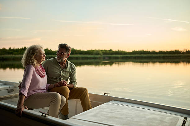 istock Senior couple enjoying romantic sunset boat trip 2204356758