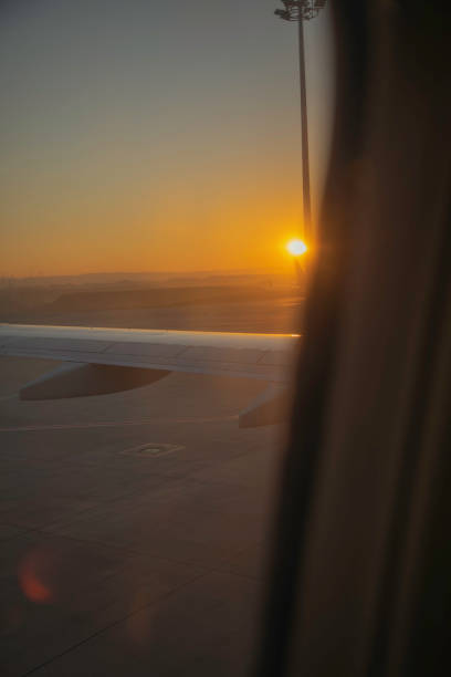 istock Sunrise View from an Airplane Window Before Takeoff 2204357592