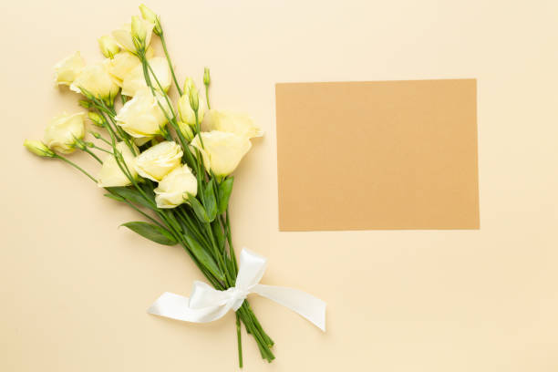 istock Card mockup with beautiful bouquet on color background, top view 2204357712