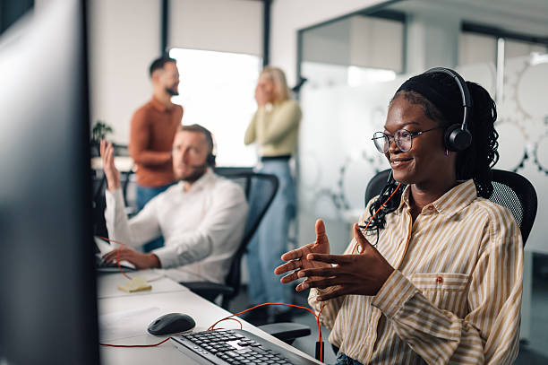 istock Customer service representative assisting clients online in busy call center 2204358612