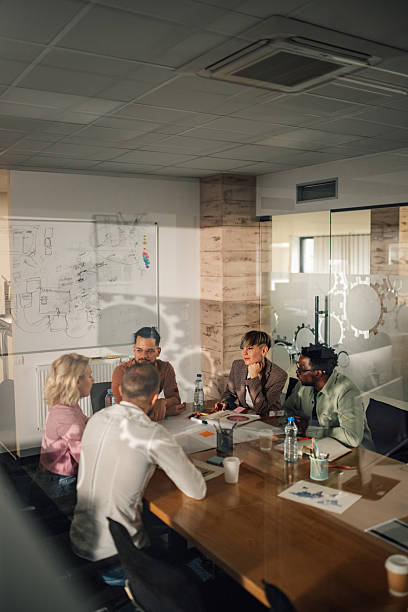 istock Diverse business team collaborating on project in modern office meeting 2204358651