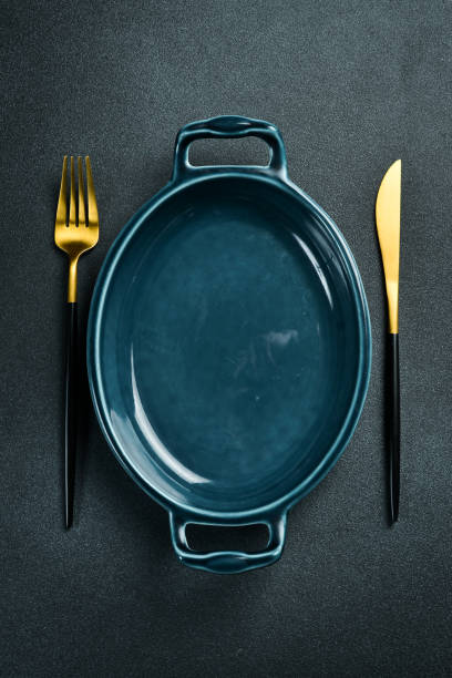 istock Oval porcelain form for baking dishes. On a black stone background. Free space for text. 2204358922