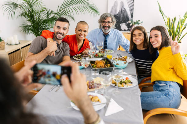 istock Multi generational family having fun together during dinner celebration at home 2204359142
