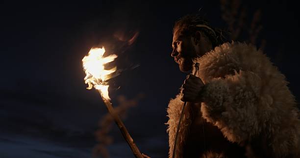 A fierce warrior stands boldly with a bright, fiery flaming torch, evoking the powerful spirit of ancient civilizations